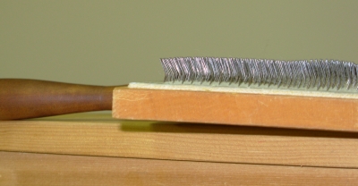 Carder teeth angled toward handle