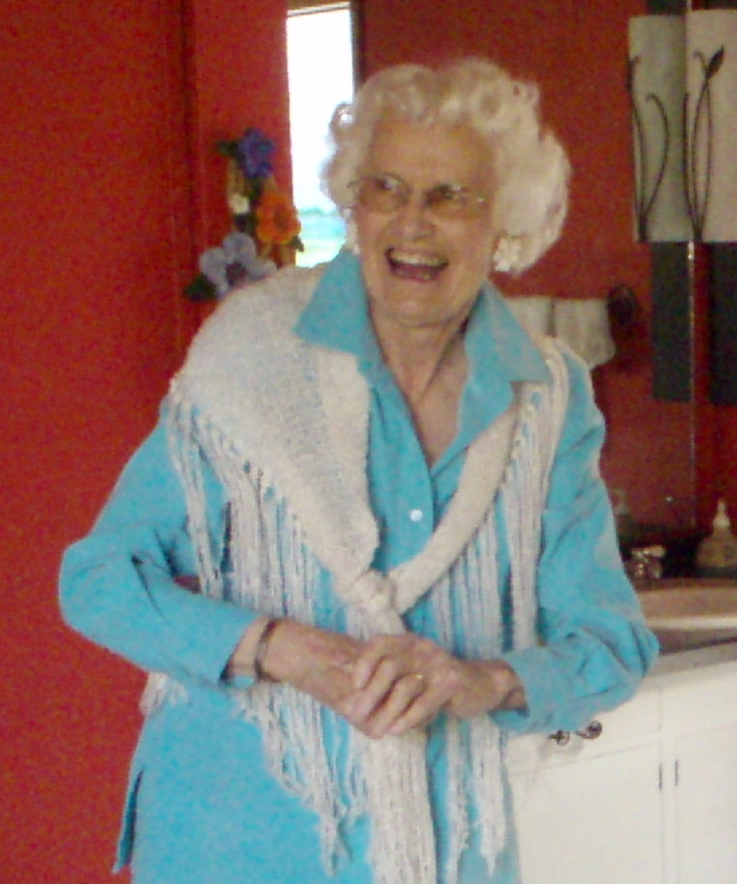 Laughing woman in white handwoven shawl.